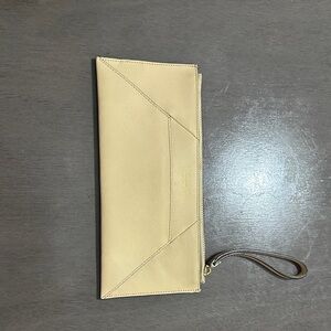 Elegant Henri Bendel Cream Clutch with Wrist Strap